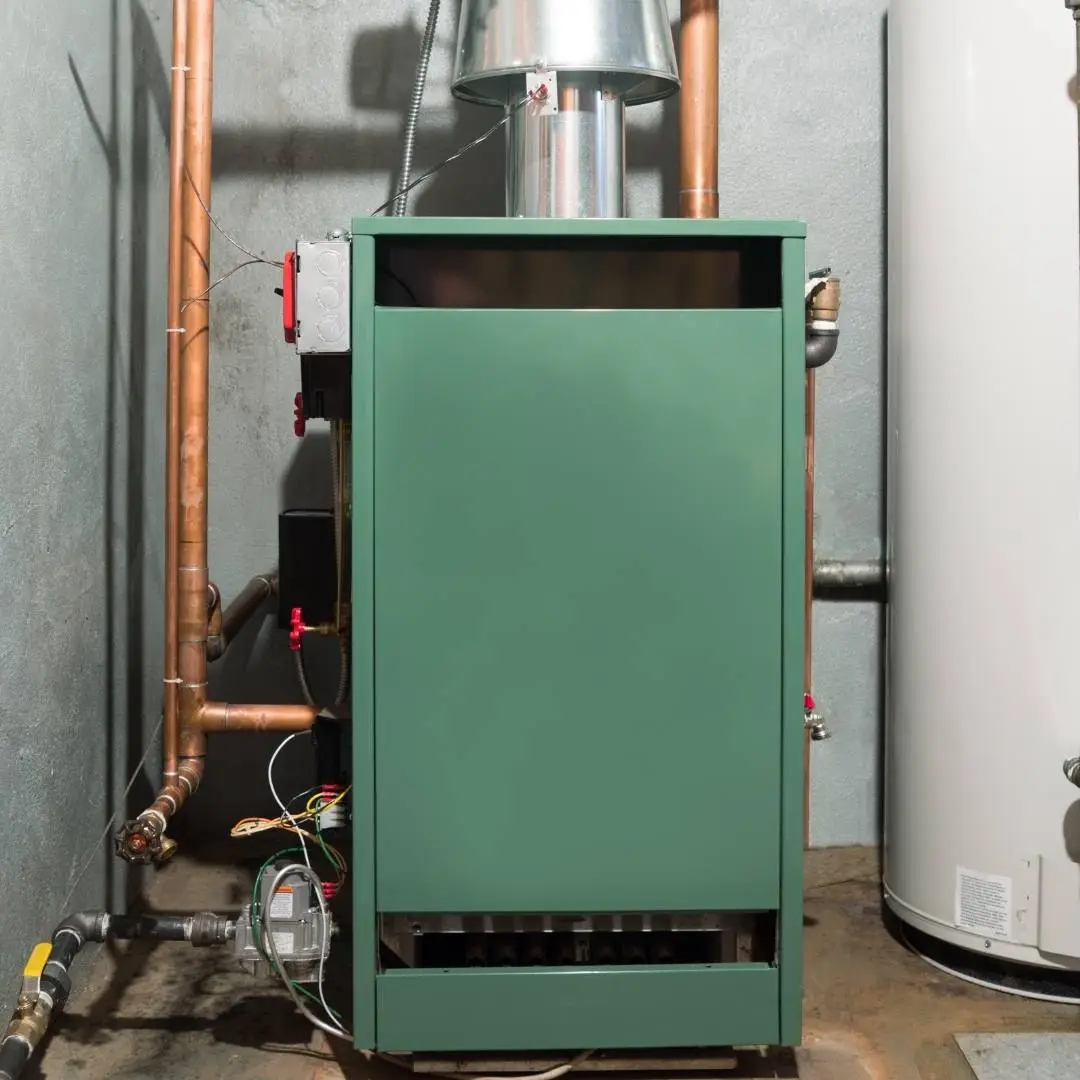 Technician servicing a home furnace
