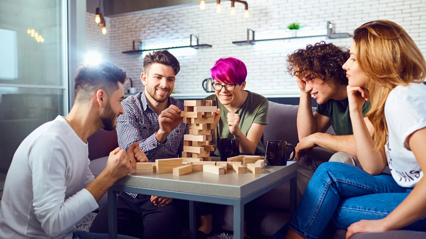 Friends relaxing and playing a game in a comfortable home