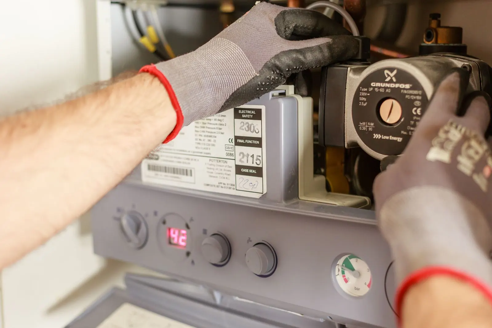 Technician inspecting the controls on a residential boiler