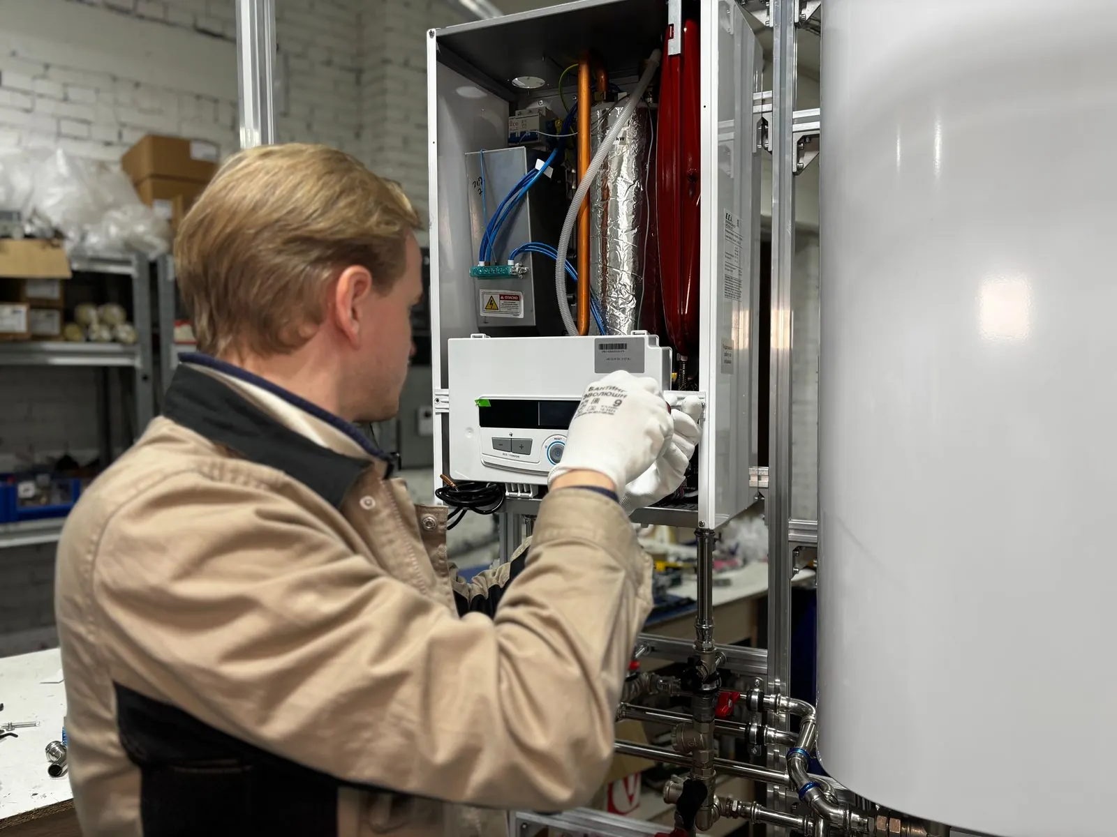 Technician testing furnace components with the panel open