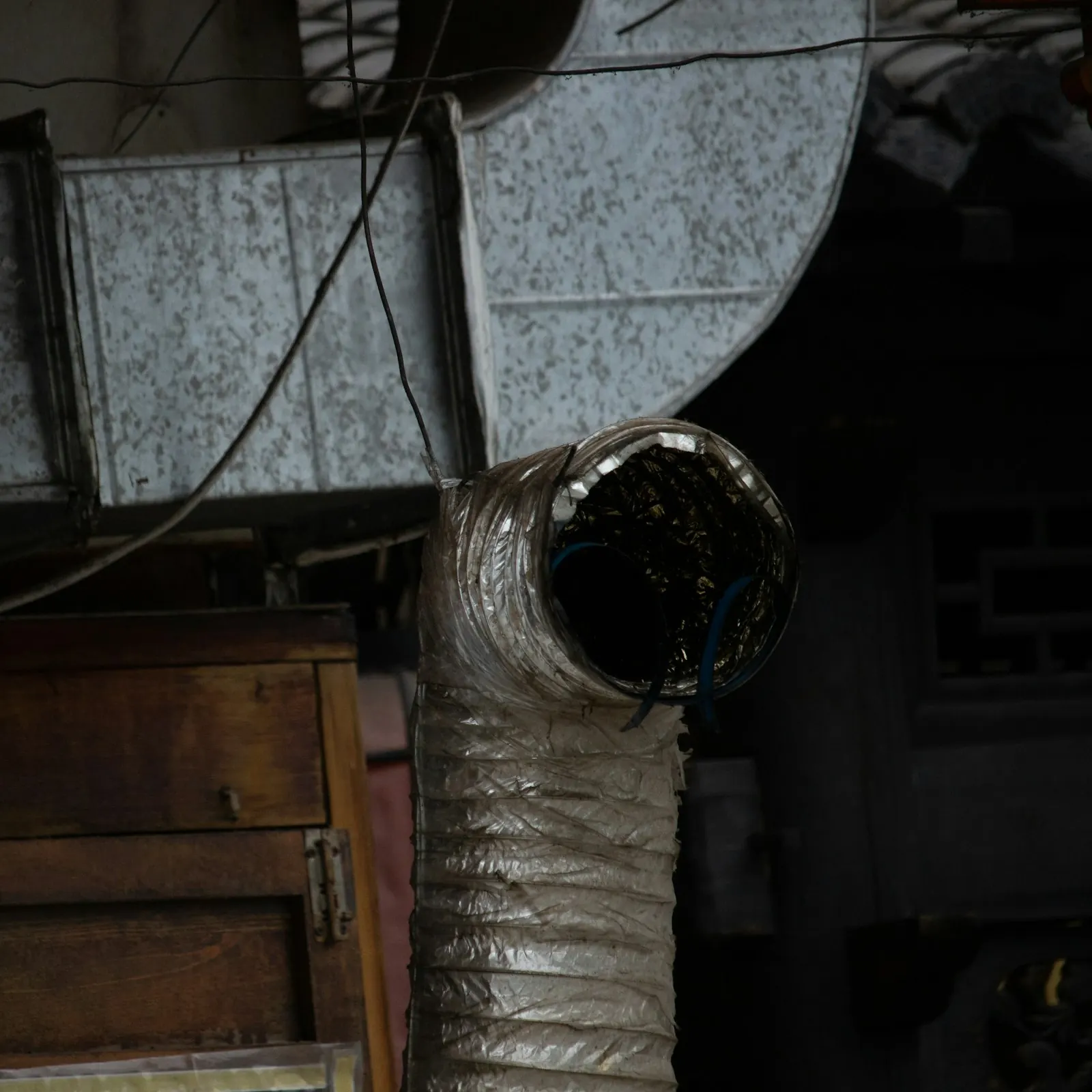 Technician connecting a new furnace to existing ductwork