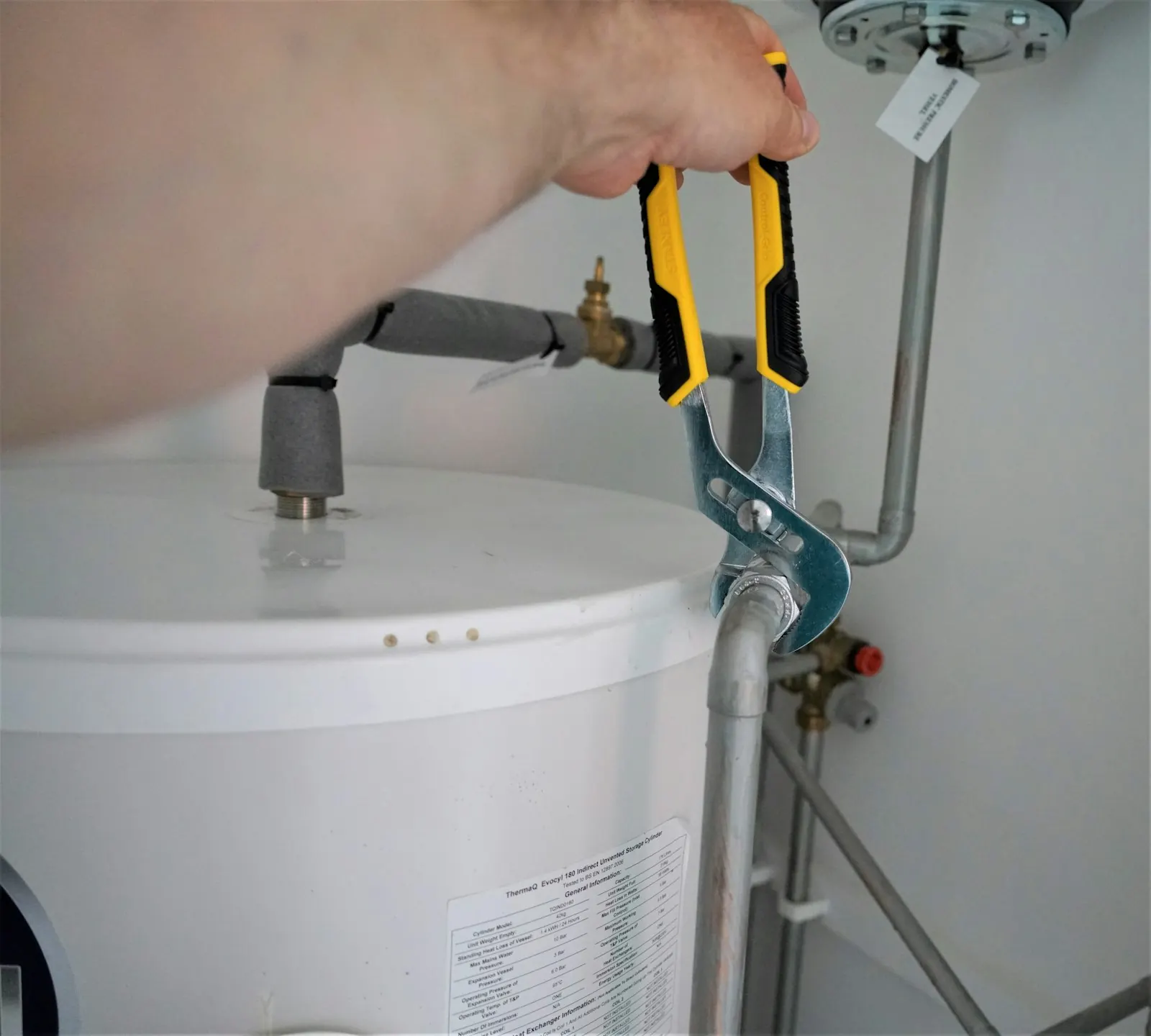 Technician testing a water heater heating element